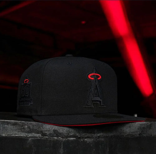 A black fitted hat with the Los Angeles Angels logo in red on the front.