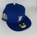 Blue baseball cap with World Series logo and New Era brand on a gray background