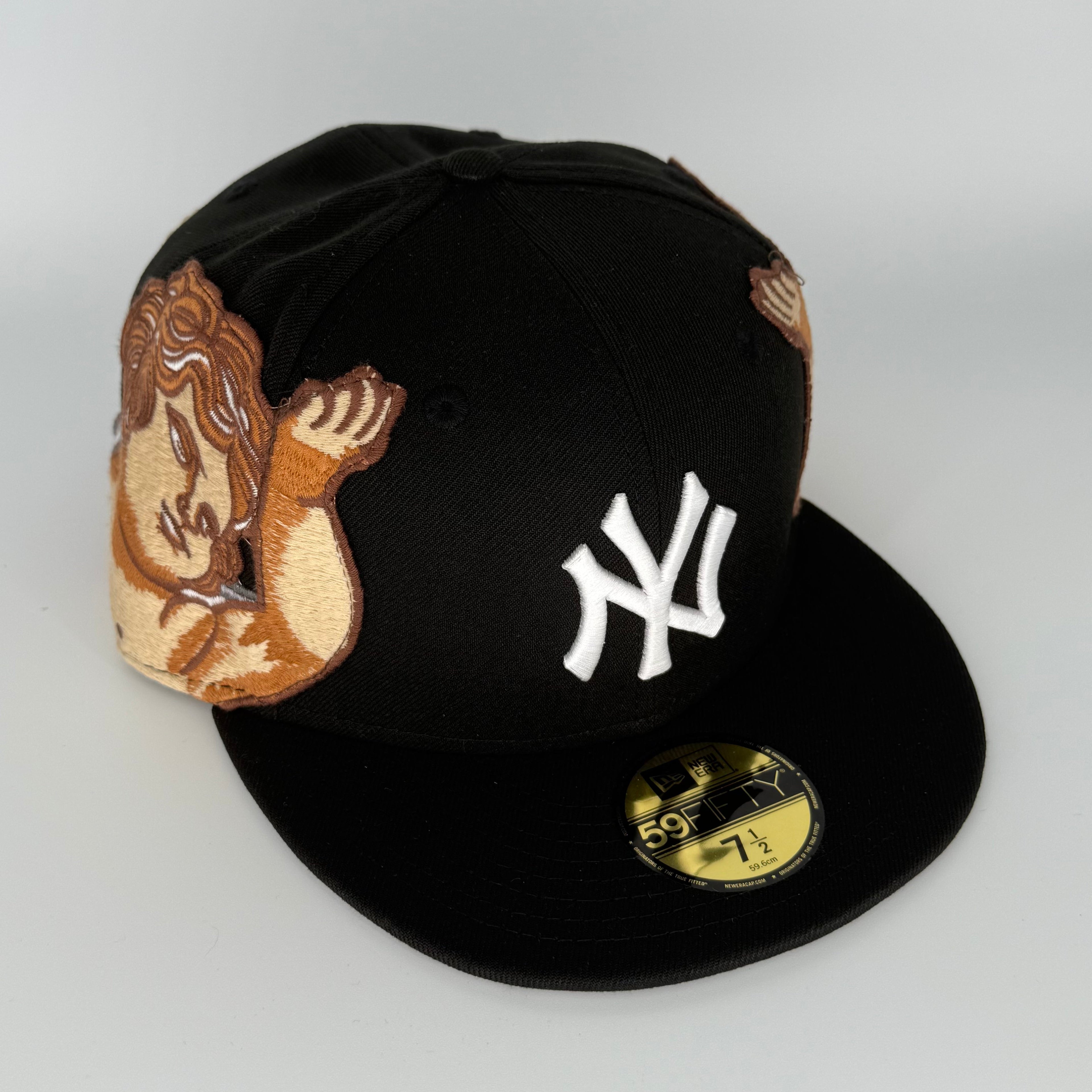 Black baseball cap with a logo and patch on a white background