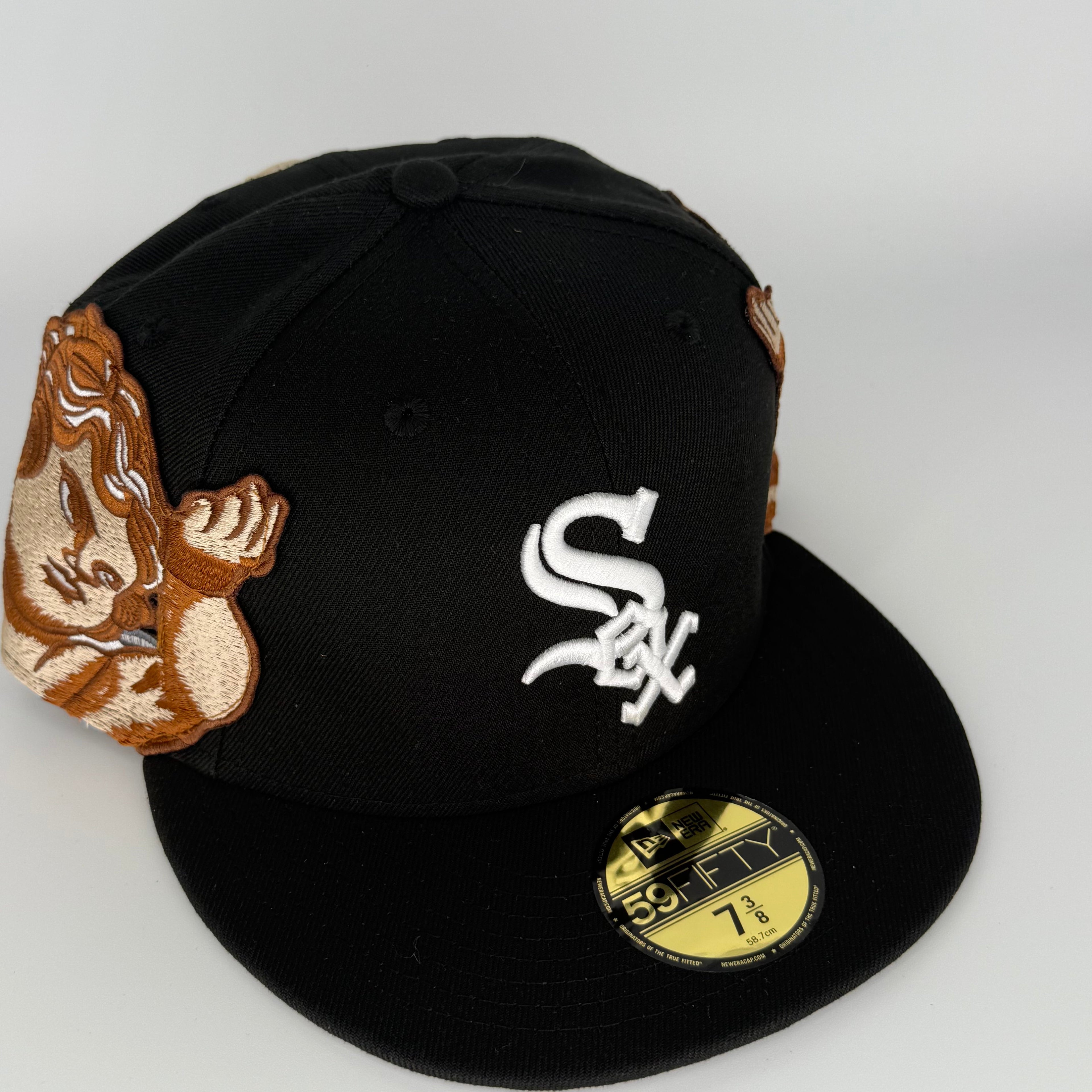 Black baseball cap with embroidered logo and decorative elements on a white background