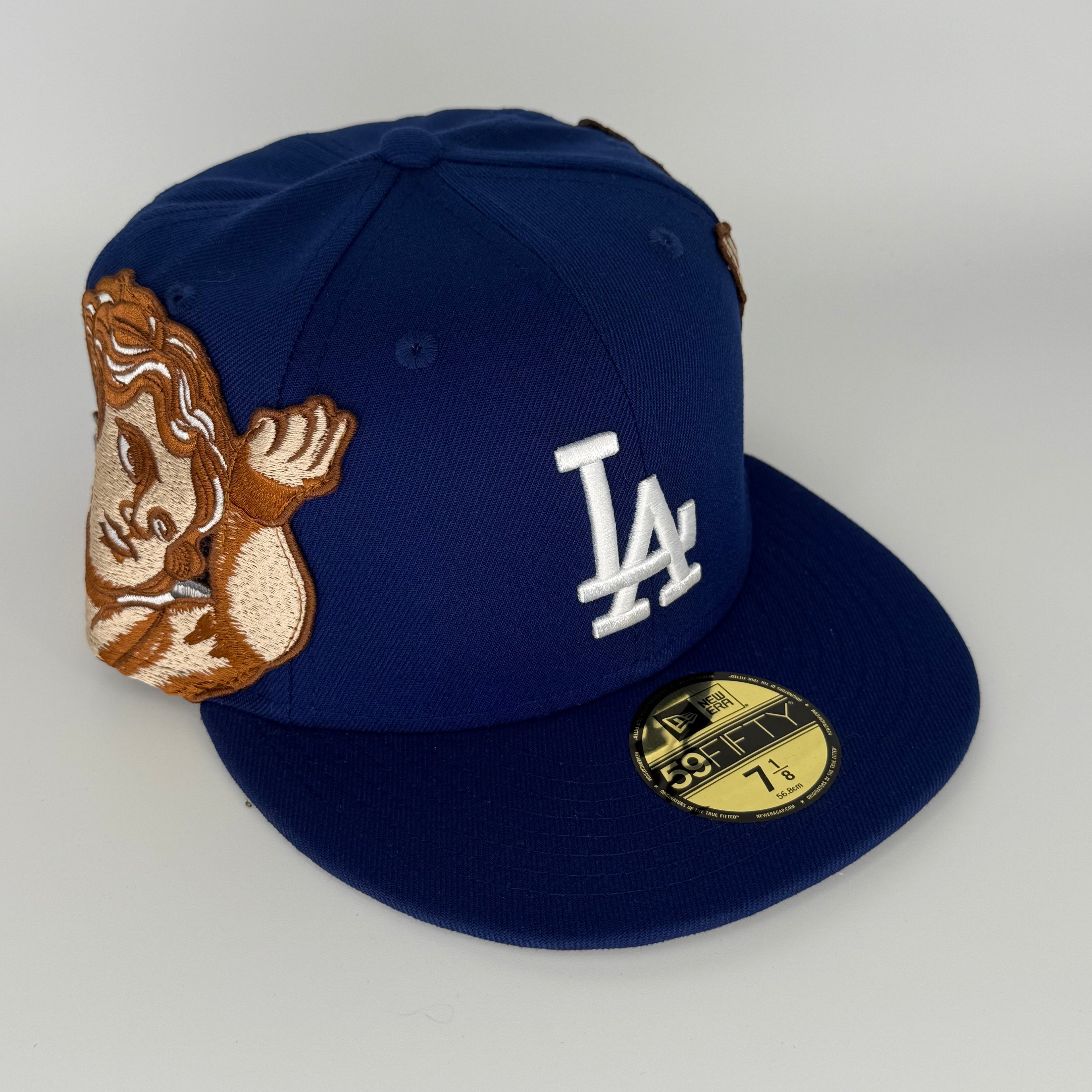 Blue baseball cap with a logo and a cartoon character on a white background