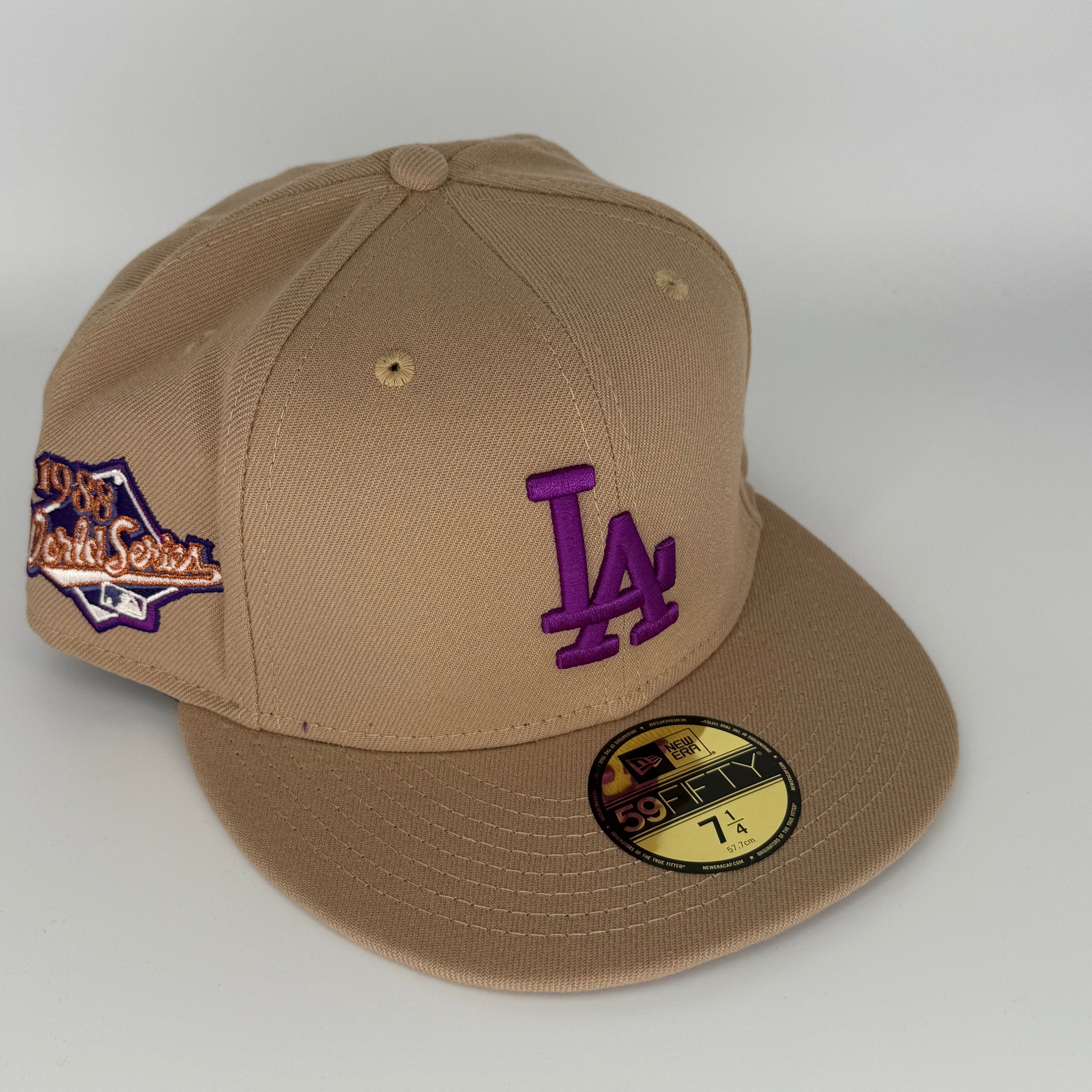Beige cap with purple 'LA' logo and World Series patch on a white background