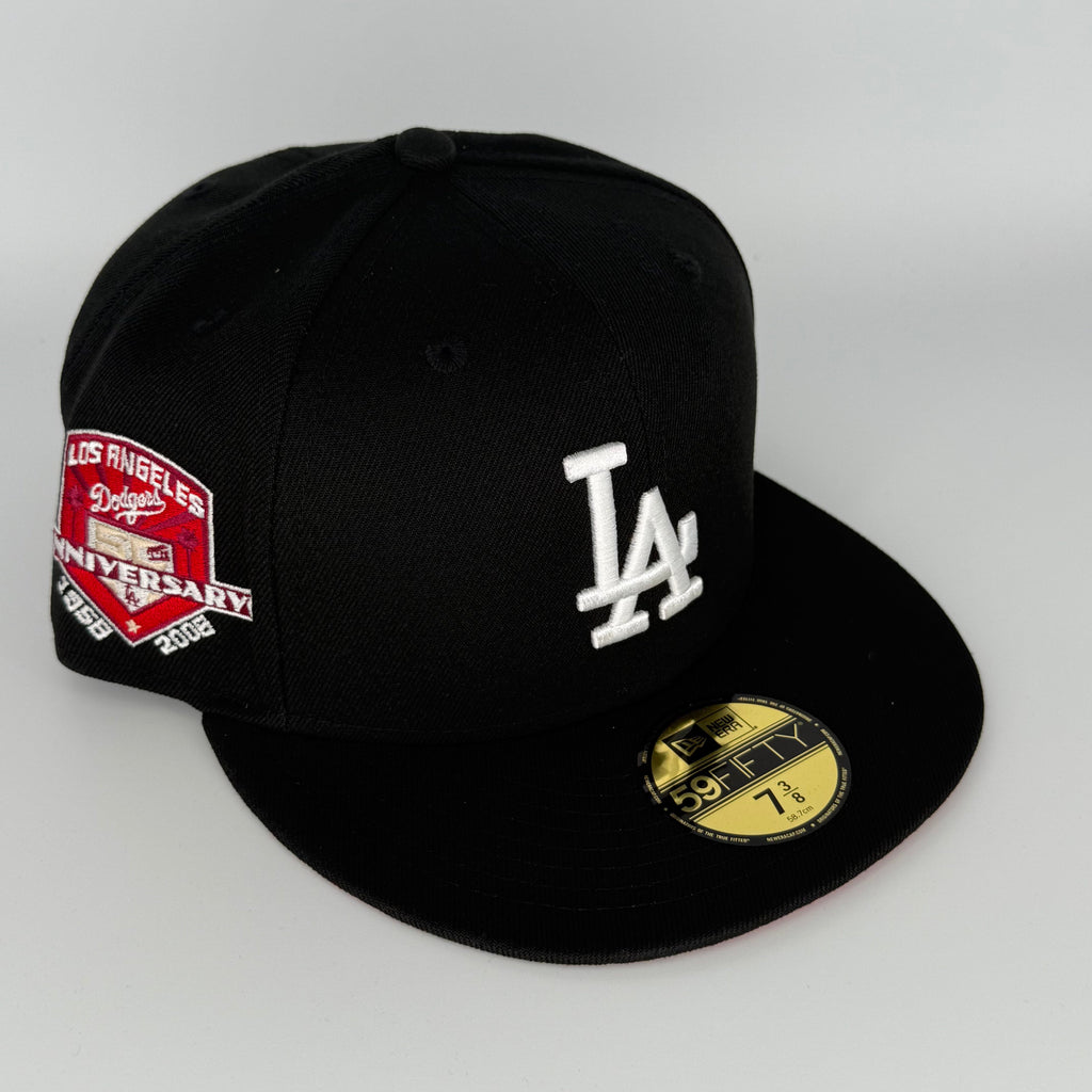 Black baseball cap with LA Dodgers logo and anniversary patch on a white background