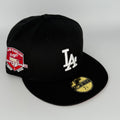 Black baseball cap with LA Dodgers logo and anniversary patch on a white background