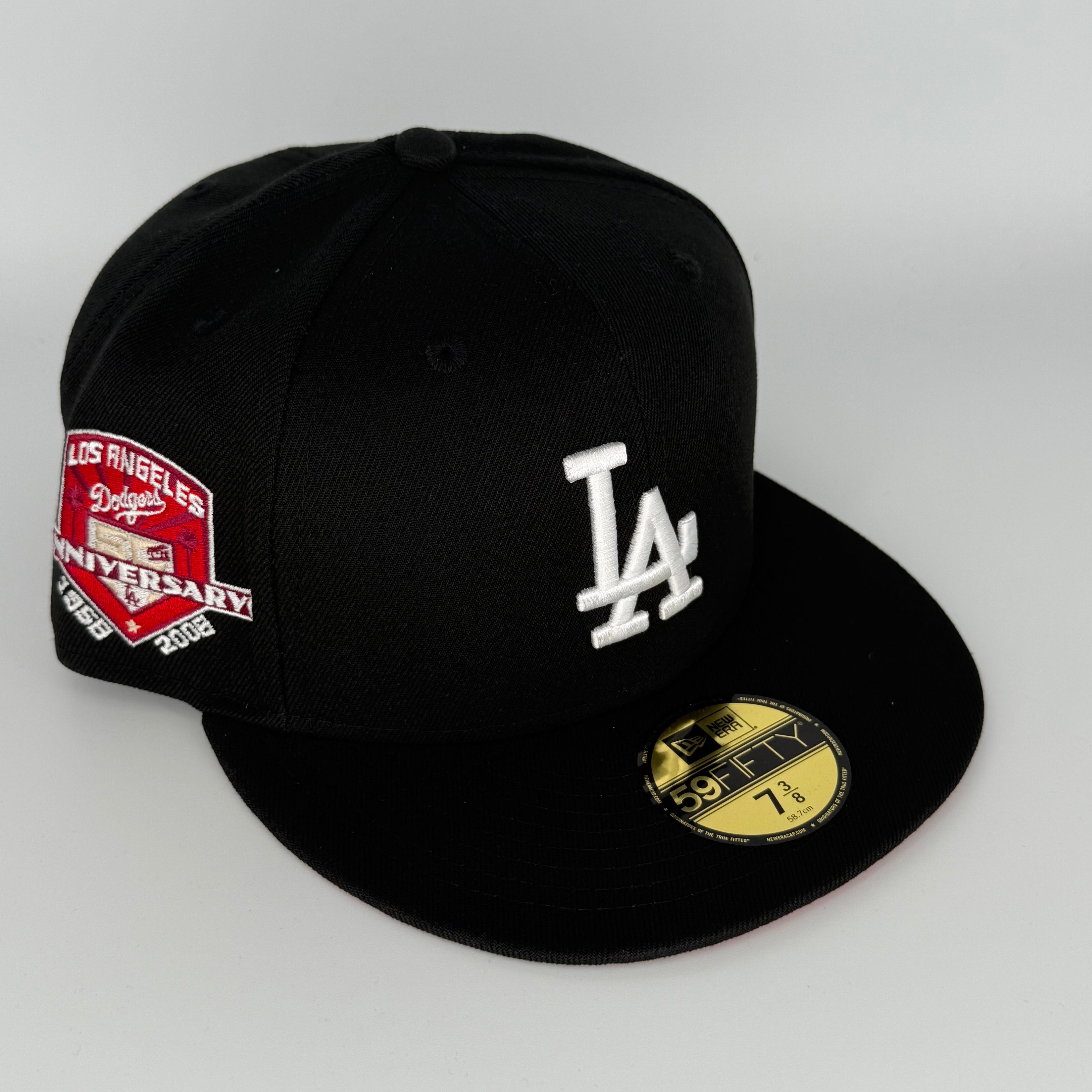 Black baseball cap with LA Dodgers logo and anniversary patch on a white background